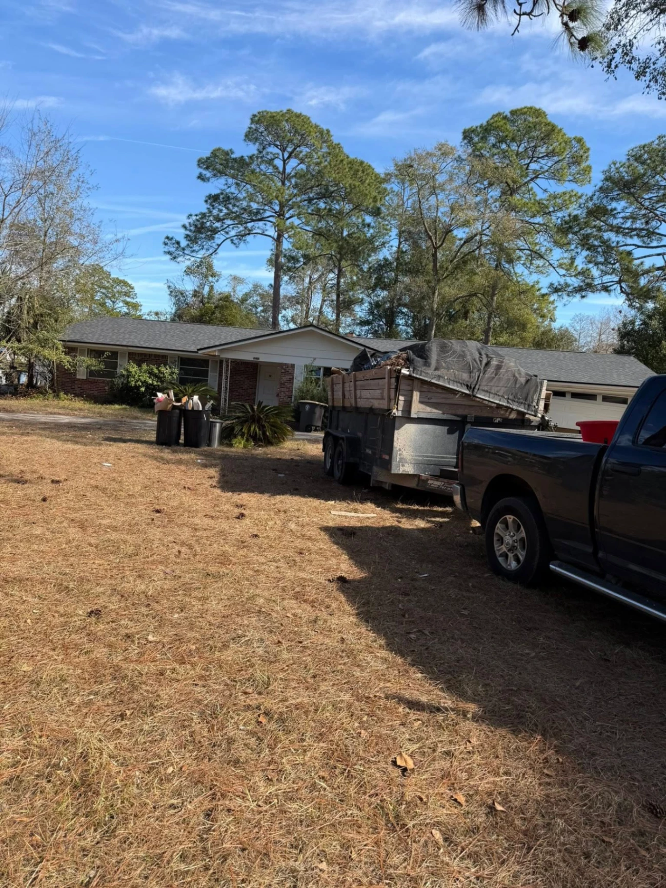 Junk removal truck loaded at residential property