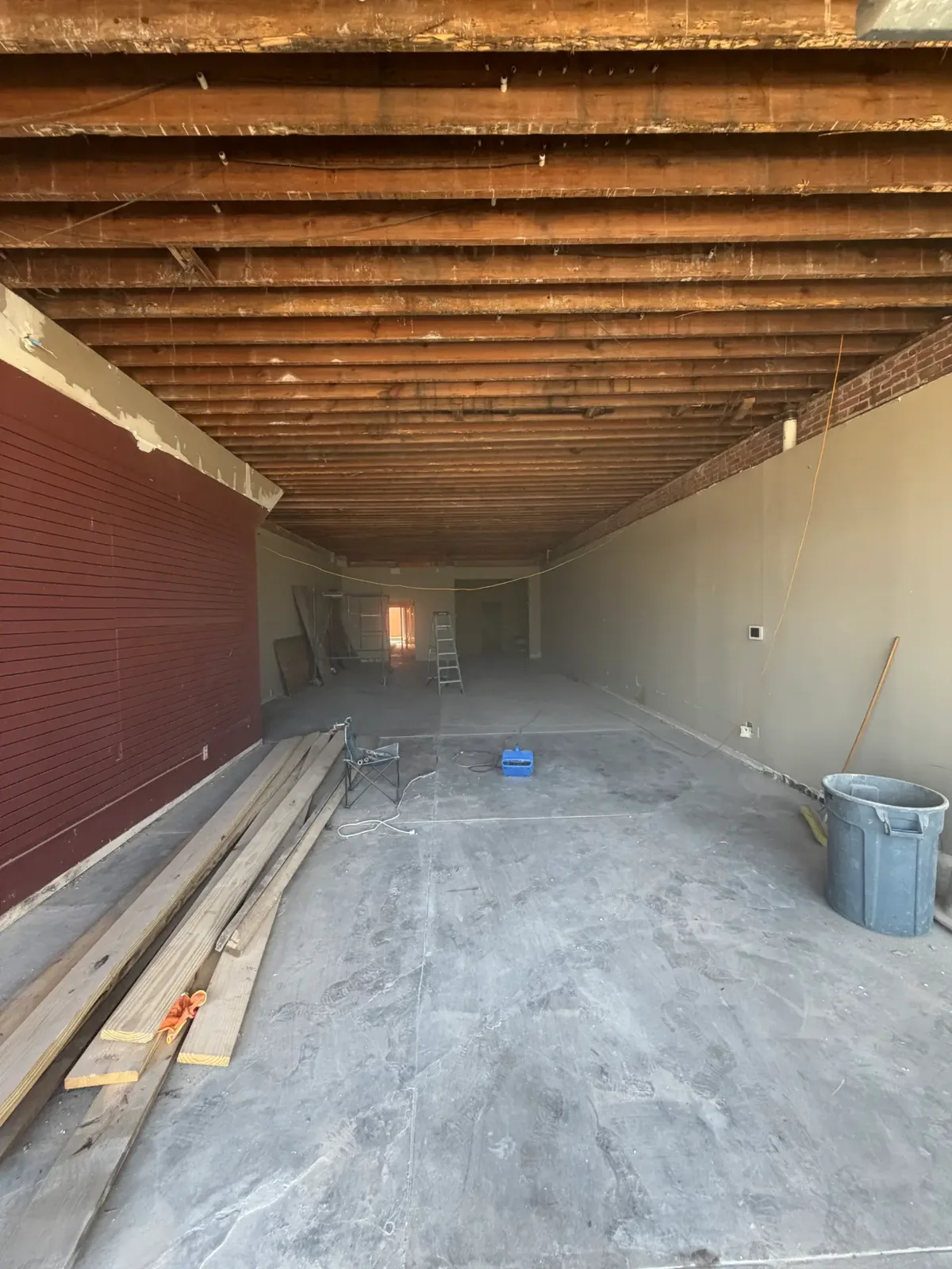 Cleared commercial interior with exposed ceiling joists after demolition